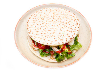 Flatbread with chicken and salad on white background top view