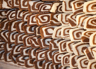 Delicious coconut biscuit roulade with chocolate cream as a back