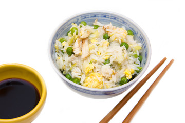 Rice with chicken and eggs on white background seen close