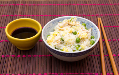 Rice with chicken and eggs on bamboo placemat