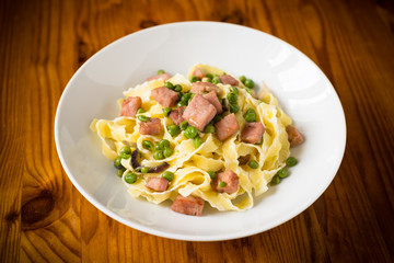Fettuccine with ham and peas, Italian cuisine