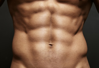 Closeup photo of an athlete with perfect abs - obrazy, fototapety, plakaty