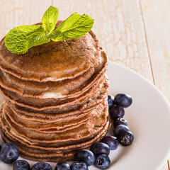 Homemade chocolate pancakes with berries