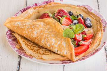 Homemade crepes with berries and fruit