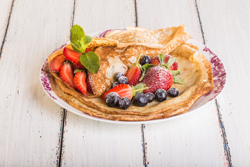 Homemade crepes with berries and fruit
