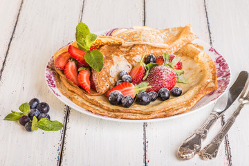 Homemade crepes with berries and fruit