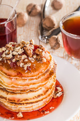 Homemade pancakes with walnuts and strawberry jam