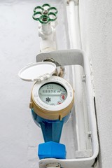 A brass metal domestic household water meter and stopcock