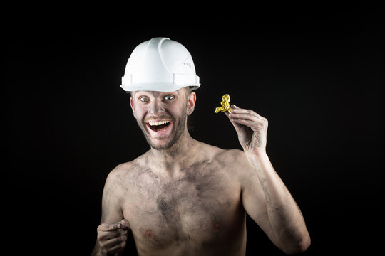 happy  miner shows a golden nugget