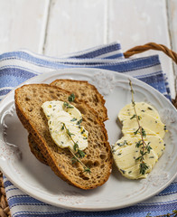 Slices of fresh bread with butter on the grass.