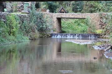 Fototapeta na wymiar Old stone bridge over the canal.