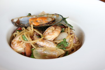 Thai syle spaghetti seafood in white dish.