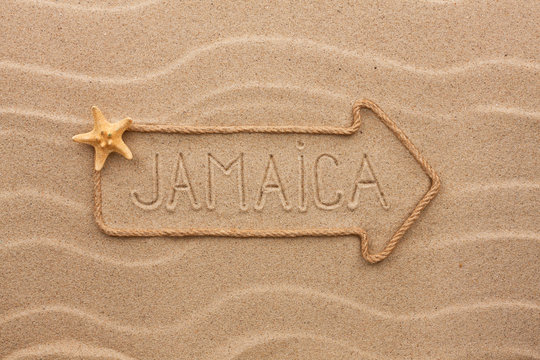 Arrow made of rope and sea shells with the word Jamaica on the s