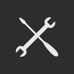 White crossed tools on dark grey background