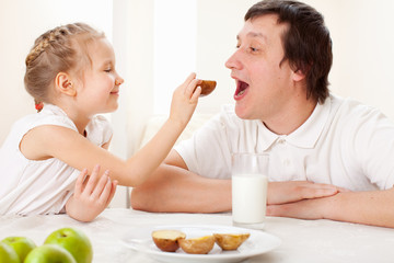 Child with father have a breakfast