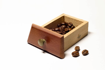 coffee beans in wooden drawer close up in studio