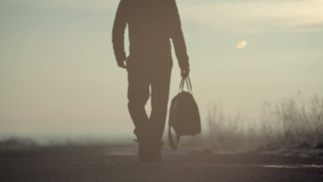 A man with a bag on the road