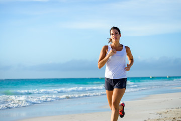Sporty woman running at tropical beach