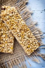 Muesli bars, cereal bars on the wooden background.