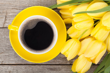 Fresh yellow tulips bouquet and coffee cup