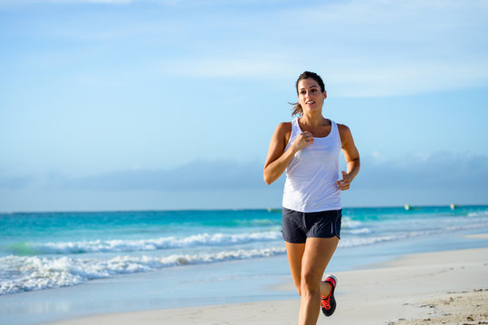 Sporty Woman Running At Tropical Beach