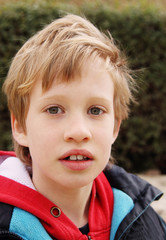 Outdoor portrait of 7 years old boy