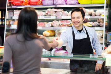 Shopkeeper serving a customer in a grocery store