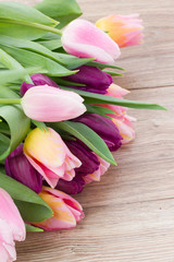 pink tulips on wooden table