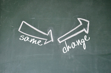 same and change arrow sign on blackboard