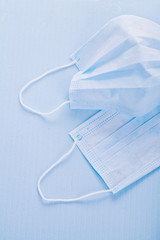 disposable face masks on blue background