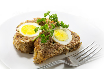 slices of meatloaf with boiled eggs for Easter