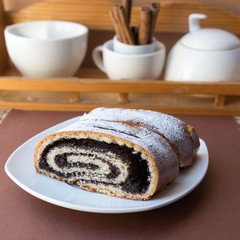 Sweet roll with poppy seeds on the plate