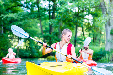 Freunde fahren im Kajak auf Wald Fluss 
