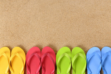 Beach sand background with row or line border of flip flop sandals summer holiday vacation photo