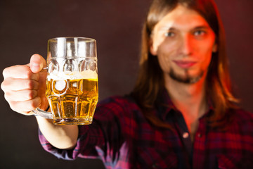 handsome young man holding a mug of beer