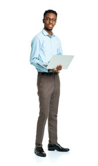 Happy african american college student standing with laptop on w