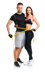 Man and woman with measuring tape on the white background