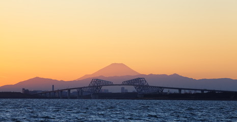 Tokyo bay at sunset with Tokyo gate bridge and Mountain Fuji