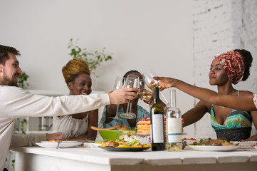 Young Friends Enjoying Meal at Home © Milles Studio