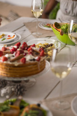 Woman eating at home and drinking wine