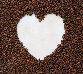 Cedar wood nuts background with white heart on it