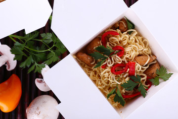 Chinese noodles in takeaway box closeup