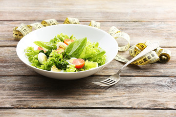 Salad with quail egg and basil in plate