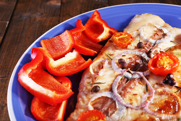 Dish of Pangasius fillet with spices and vegetables