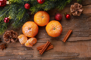Christmas composition with tangerines on wooden background