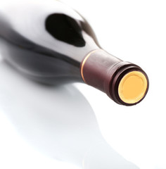 Lying red wine bottle, isolated on white