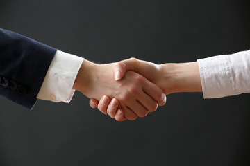 Business handshake on dark background