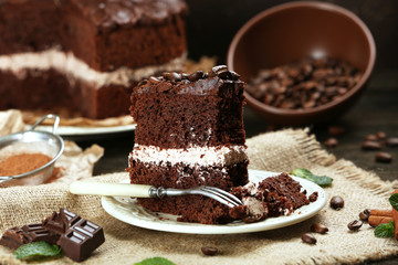 Delicious chocolate cake on table on brown background