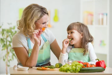  kid girl and mother eating healthy food vegetables © Oksana Kuzmina