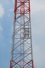 Fototapeta na wymiar Telephone pole on blue sky background.